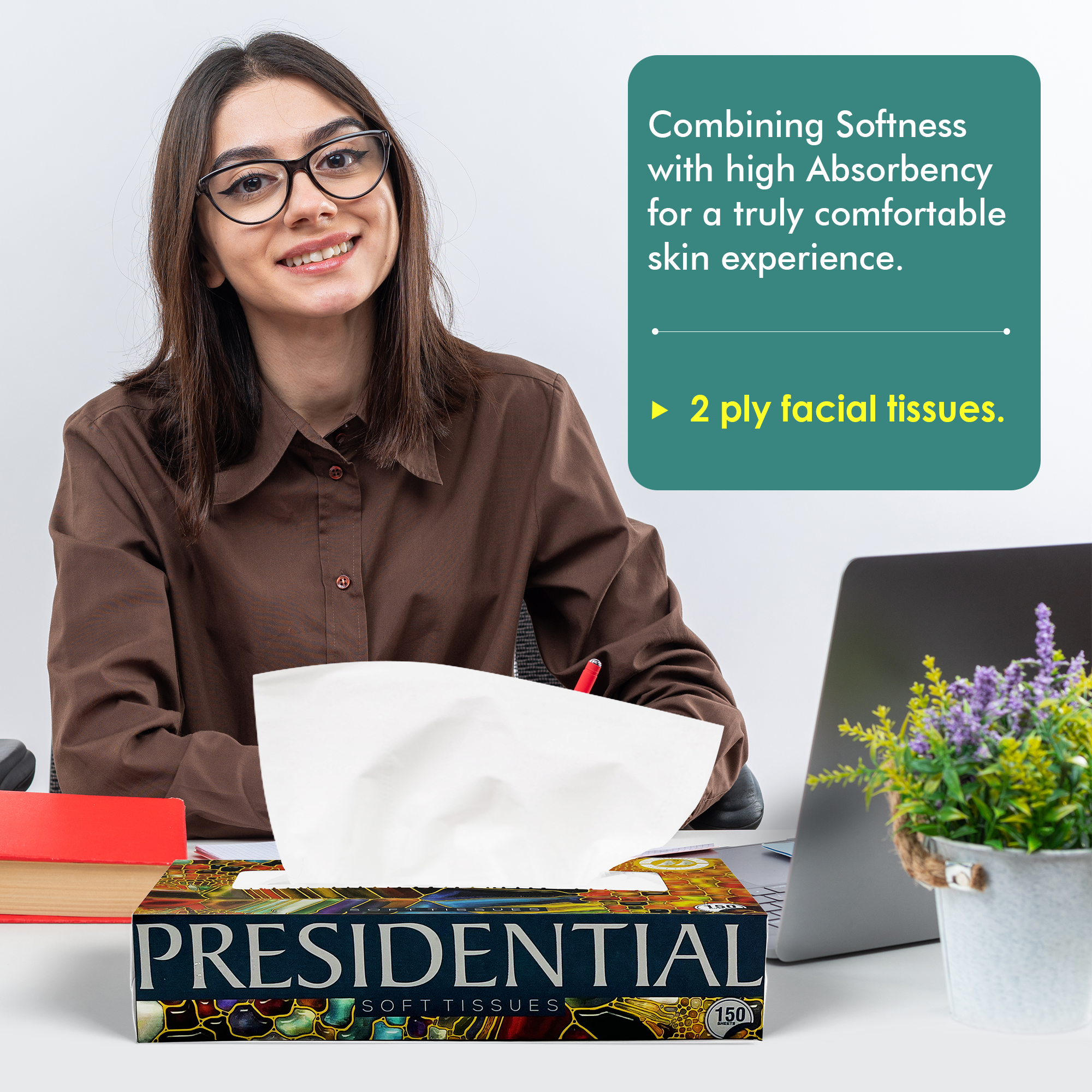 Presidential soft absorbent tissues box on desk with a woman using a tissue at her workspace